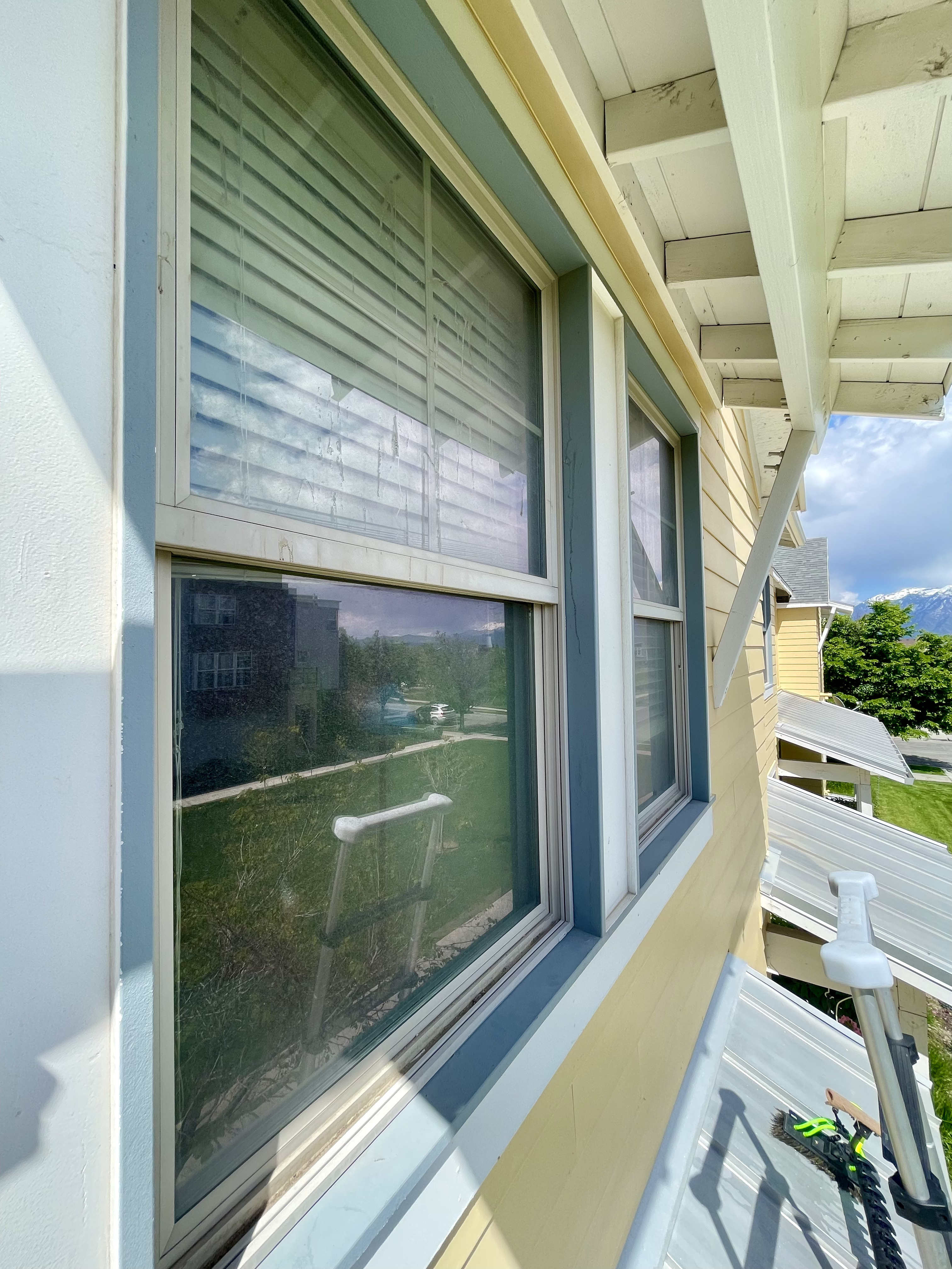 Exterior side windows of a home with dirt and dull reflections